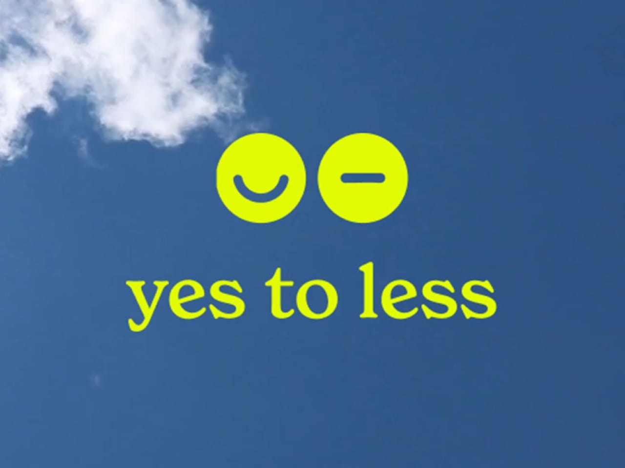 Yellow 'yes to less' text with smiley and minus icons on a blue sky.