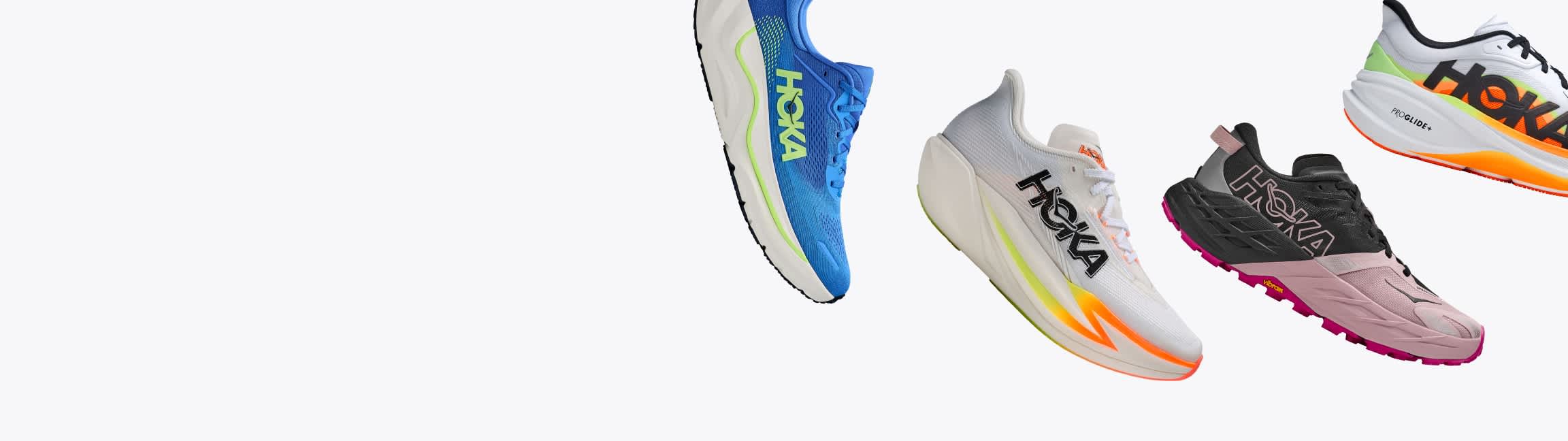Four colorful Hoka running shoes floating against a white background.