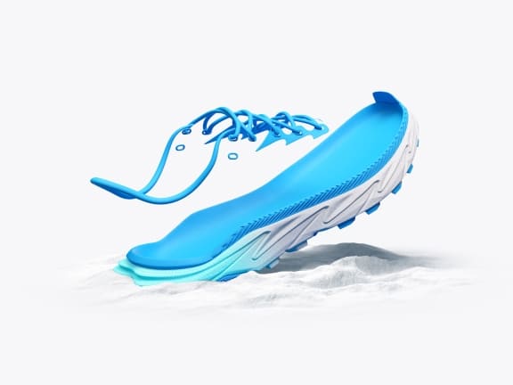 Exploded view of a blue and white shoe with separate sole, insole, and laces.