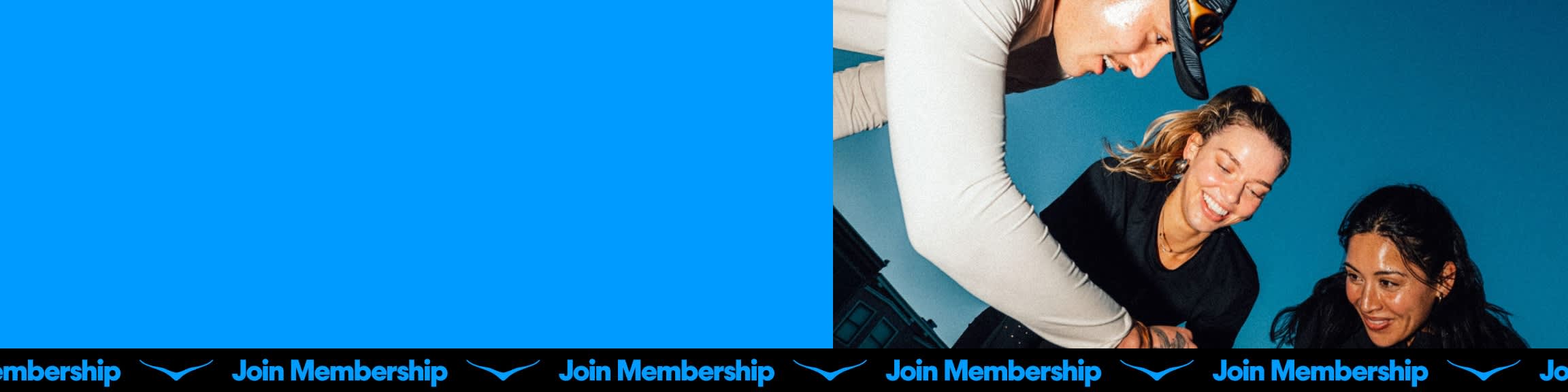 Three smiling individuals, one in a hat, on a blue background. Join Membership text.