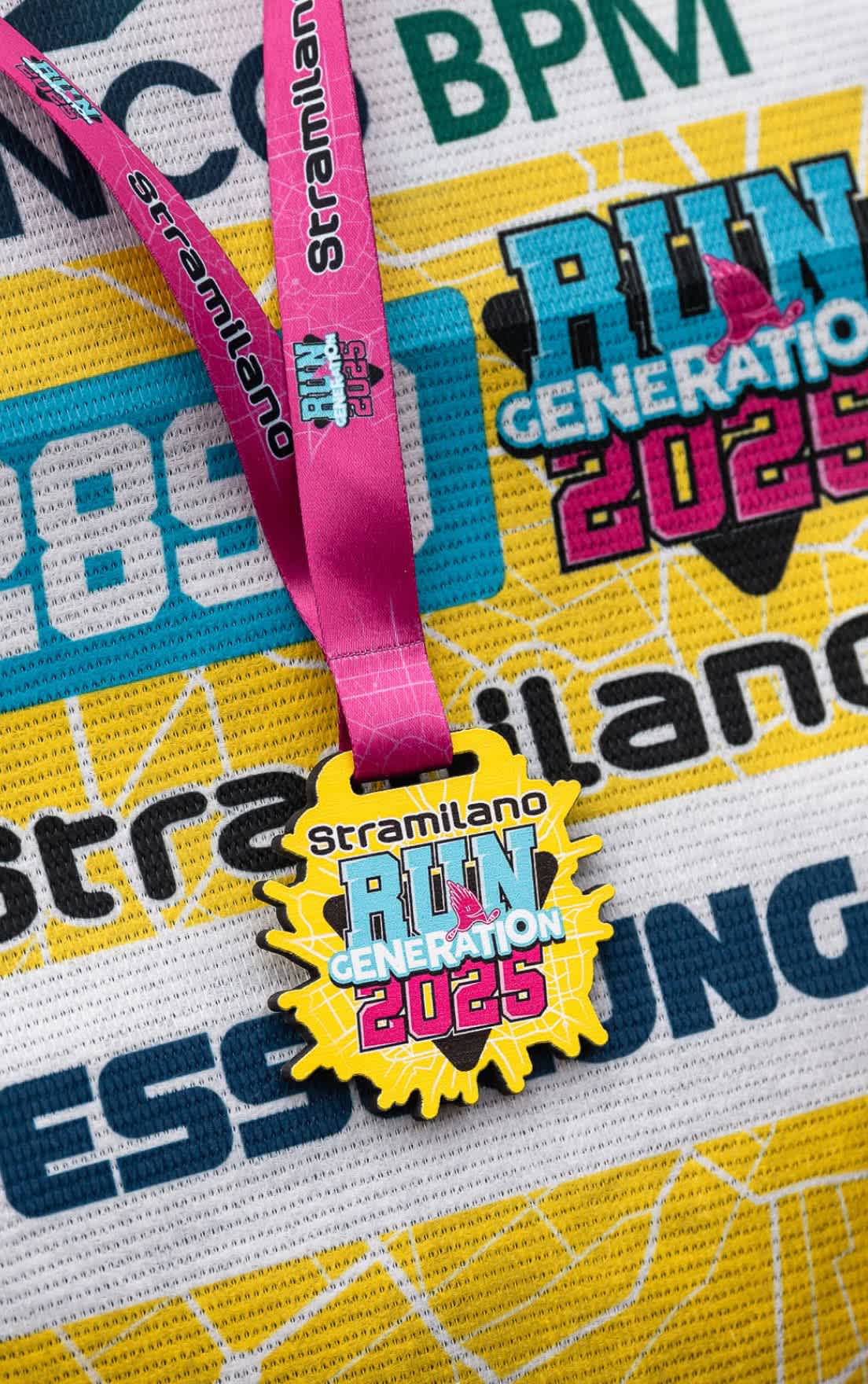 Stramilano RUN GENERATION 2025 medal on shirt with pink ribbon.