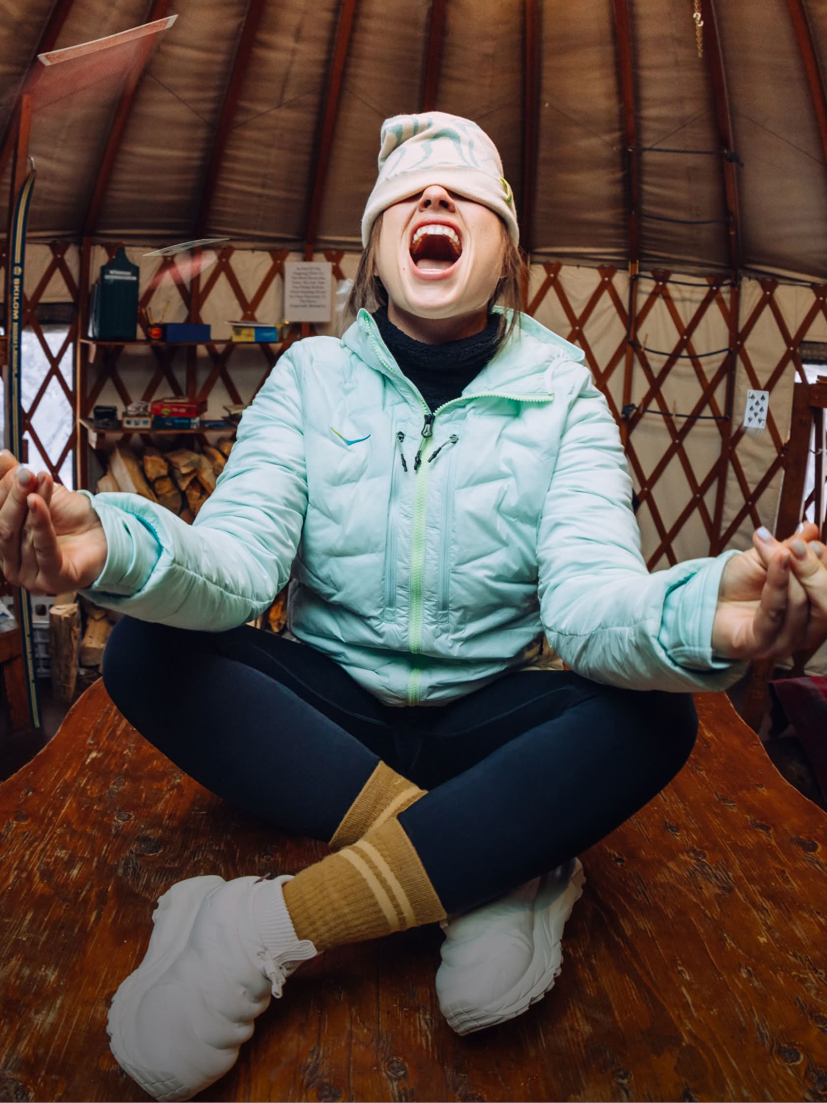 Campaign shot showing a model in a tent wearing puffer jacket and HOKA Kaha 2 Frost Moc GORE-TEX shoe.