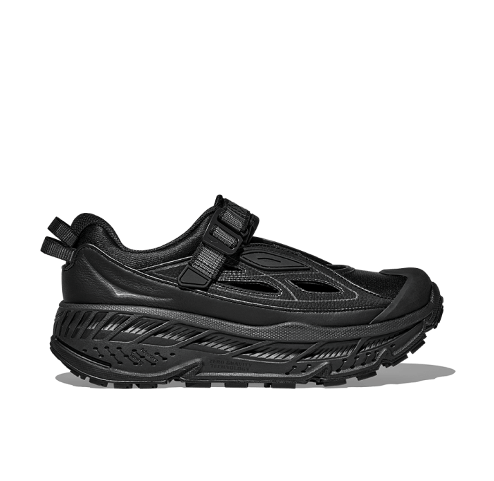 A product shot showing the HOKA Stinson Breeze hiking and trail sandal.