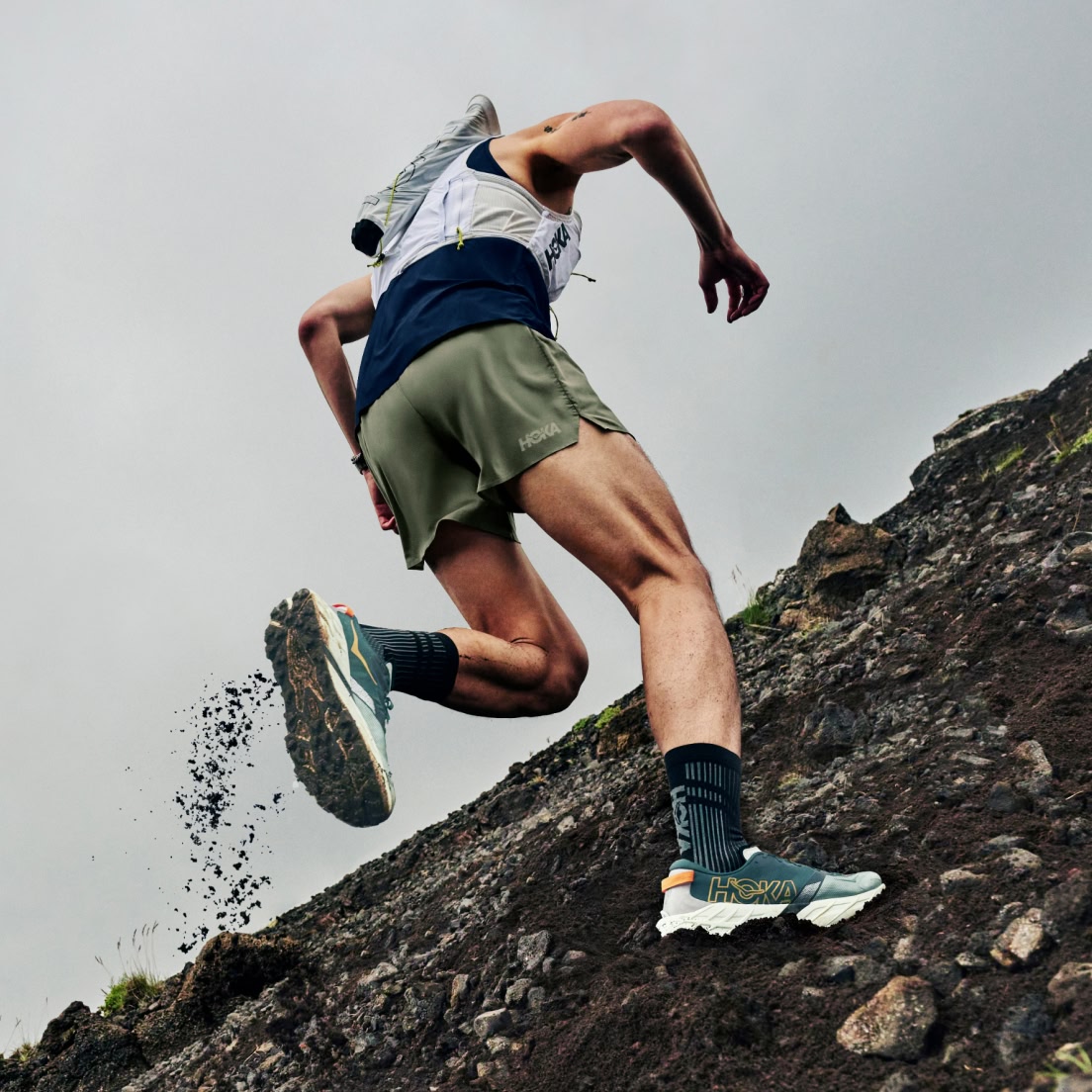 Image showing a trail runner ascending a rocky mountainside