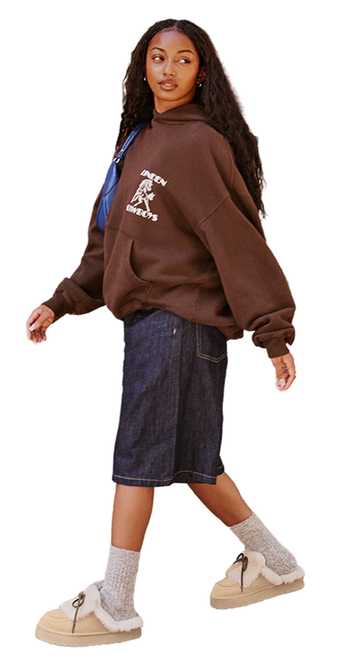 Person in brown hoodie, denim shorts, and fur-lined shoes with a blue bag.