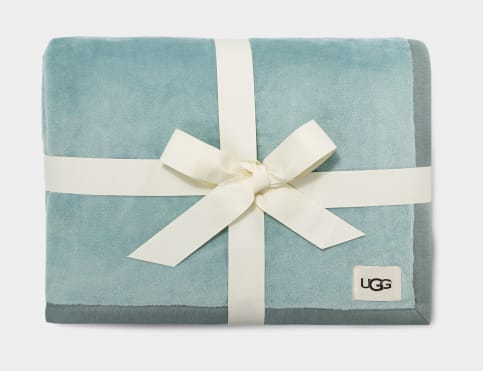 calm waters blue UGG throw blanket packed with a white ribbon