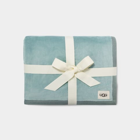 calm waters blue UGG throw blanket packed with a white ribbon