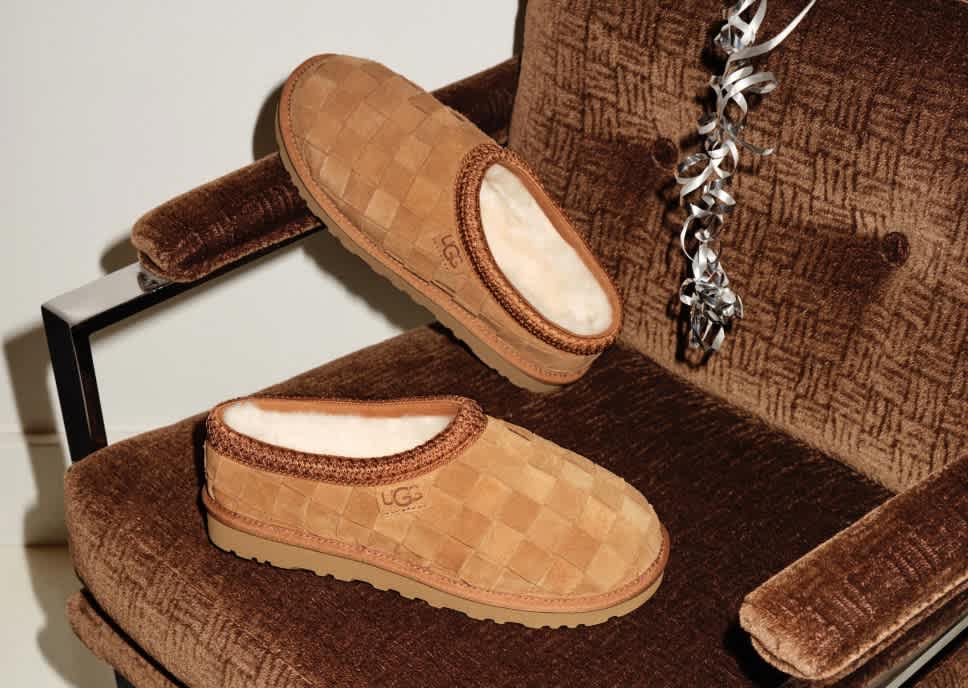 Two brown checkered UGG slippers on a brown armchair with a silver balloon