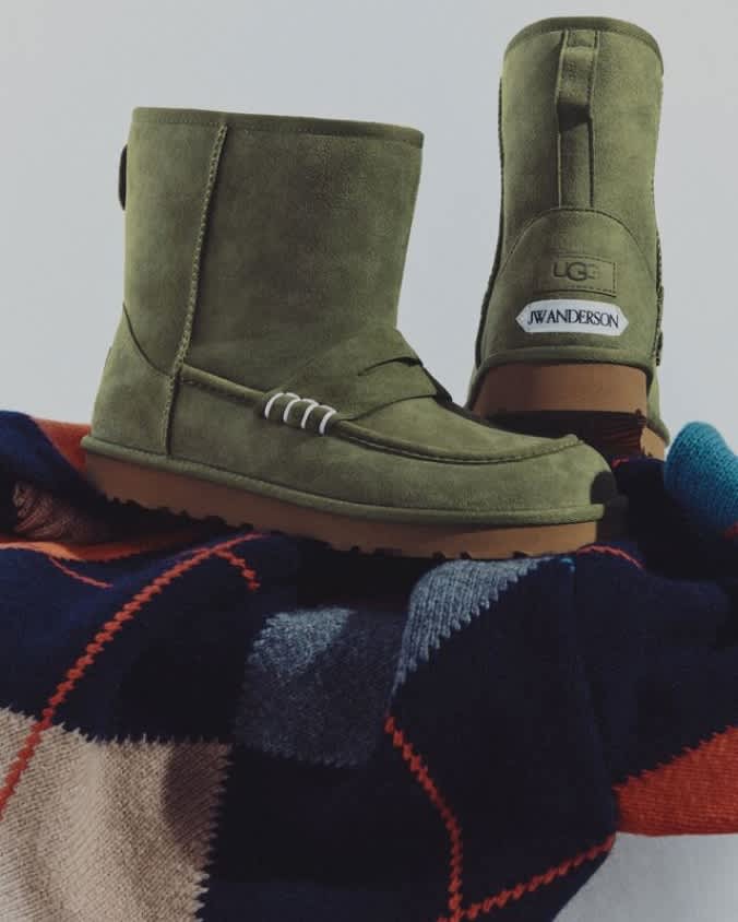 Green UGG JW Anderson boots with plush lining displayed on a knitted sweater.