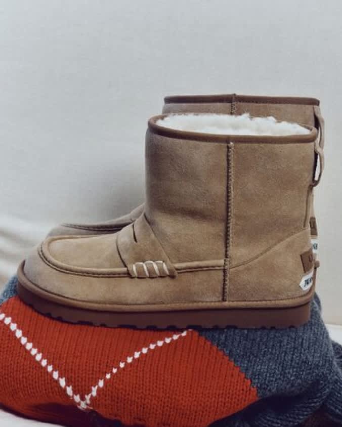 Chestnut UGG JW Anderson boots with plush lining displayed on a knitted sweater.