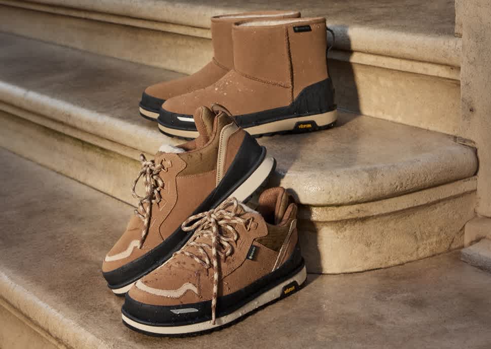 Two pairs of brown winter shoes, GTX boots and Lowmel trainers, on outdoor stone steps.