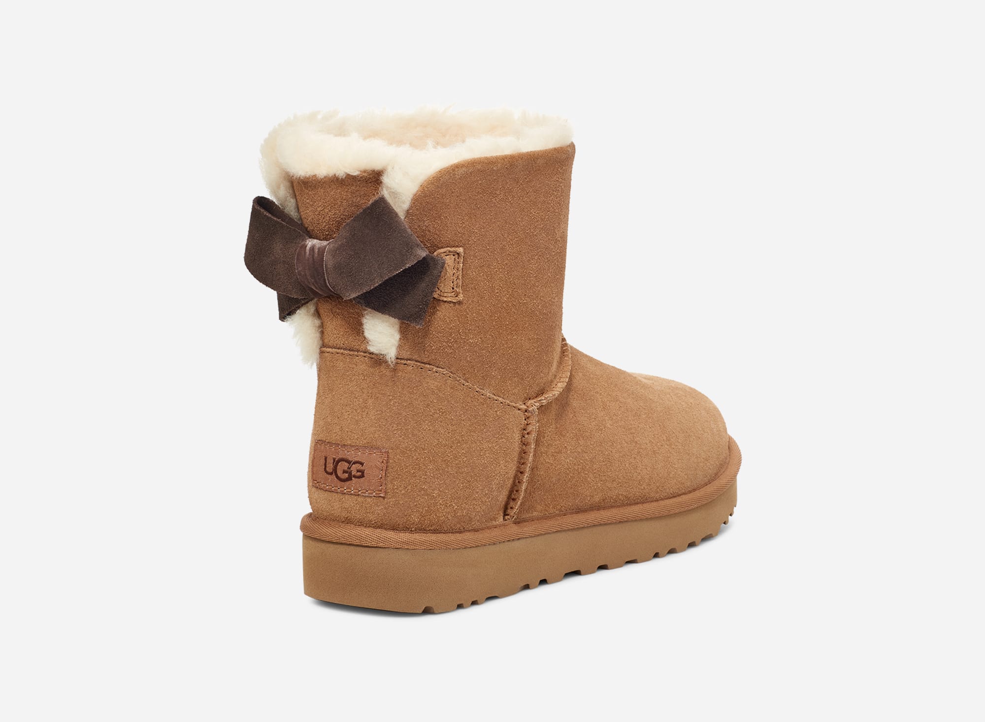 UGG® Mini Bailey Suede Bow Boot in Brown
