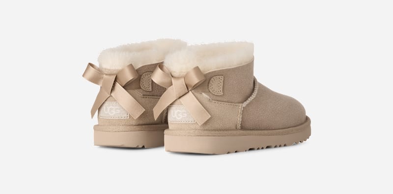 UGG® Ultra Mini Bailey Bow Boot in Tan, Size 3, Polyester/Wool