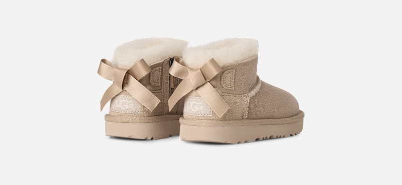 UGG® Ultra Mini Bailey Bow Boot in Tan, Size 9, Polyester/Wool