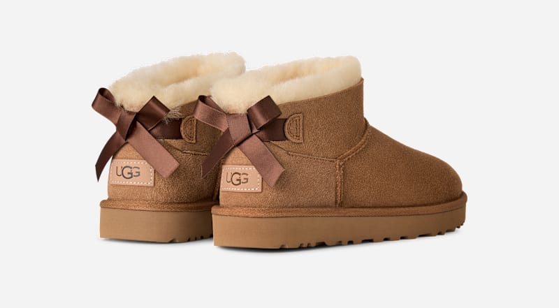 UGG® Ultra Mini Bailey Bow Boot in Brown, Size 6, Polyester/Leather
